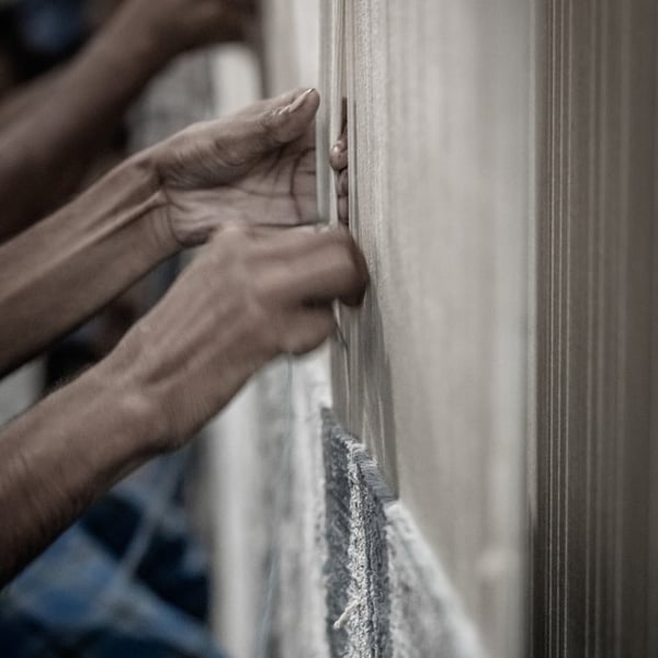 handknotting a rug on a loom