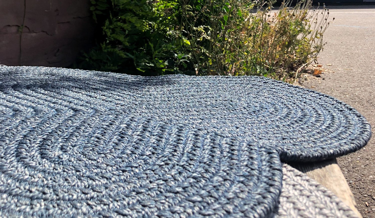 outdoor rug braided and organically shaped in blue green grey silver ash beige jute