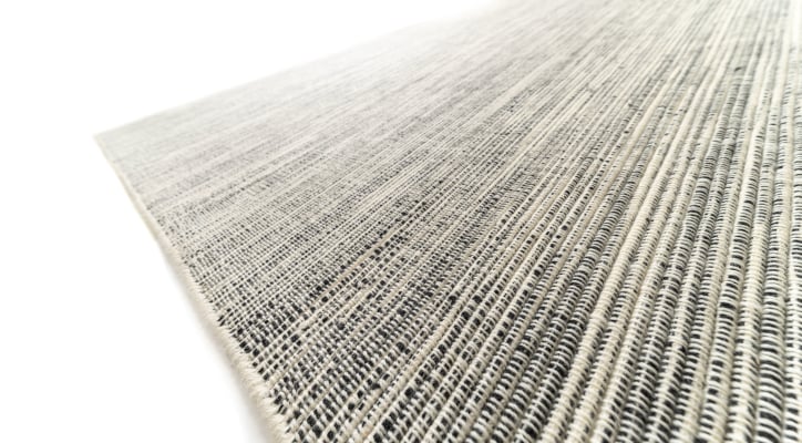 handwoven wool rug in natural colours with yellow highlight yarn