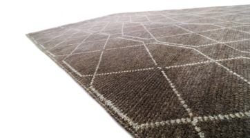 Natural honey wool rug with minimalist rose pattern.