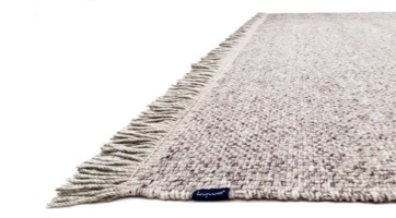 Handwoven wool rug with light chequered pattern in natural colour